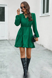 Green tiered ruffle sleeve mini dress with tie neck and elastic waist