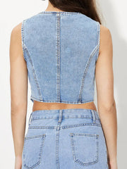 Light wash denim bustier vest with seam details and a cropped hem.