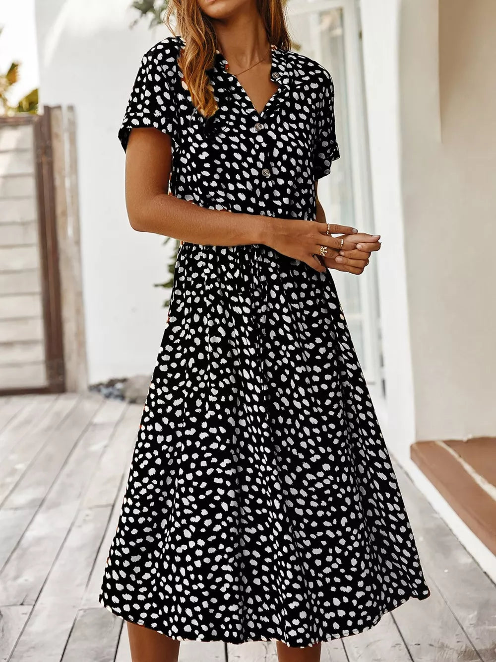 Chic animal print midi dress with tied waist, button-down, v-neck, and short sleeves.