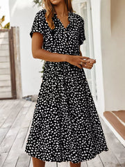 Chic animal print midi dress with tied waist, button-down, v-neck, and short sleeves.