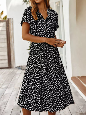 Chic animal print midi dress with tied waist, button-down, v-neck, and short sleeves.