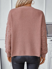 Dusty pink knit sweater with textured sleeve details and a ribbed crew neck.