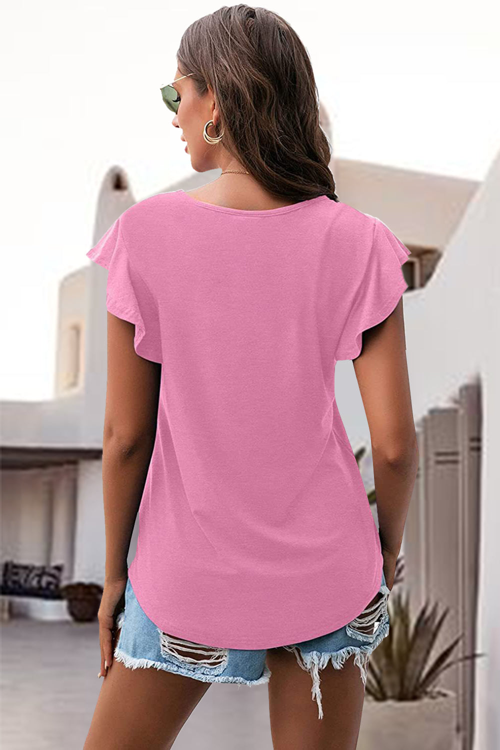 Pink t-shirt with ruffled short sleeves and a scoop neckline.