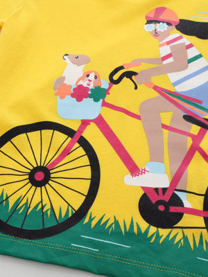 Yellow cotton crew neck t-shirt with a bicycle adventure graphic featuring a girl, animals in a basket, and grass.