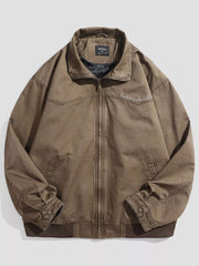 Brown cotton zip-up jacket with embroidered detail on shoulder and pockets.
