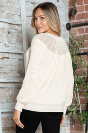 Cream ribbed knit pullover sweater with lace yoke detail and long sleeves.