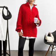 Red cable knit zip-neck sweater with a mock neck, styled with a white shirt and black leggings.