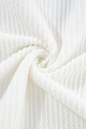 White ribbed knit sweatshirt fabric detail with vertical textured pattern.