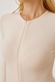 Tan ribbed bodysuit with long sleeves and a zip-front plunge neckline.