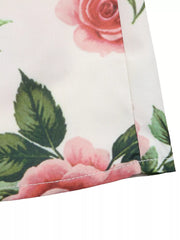 Elegant floral maxi skirt with pink roses and green leaves, showing pleated detail.