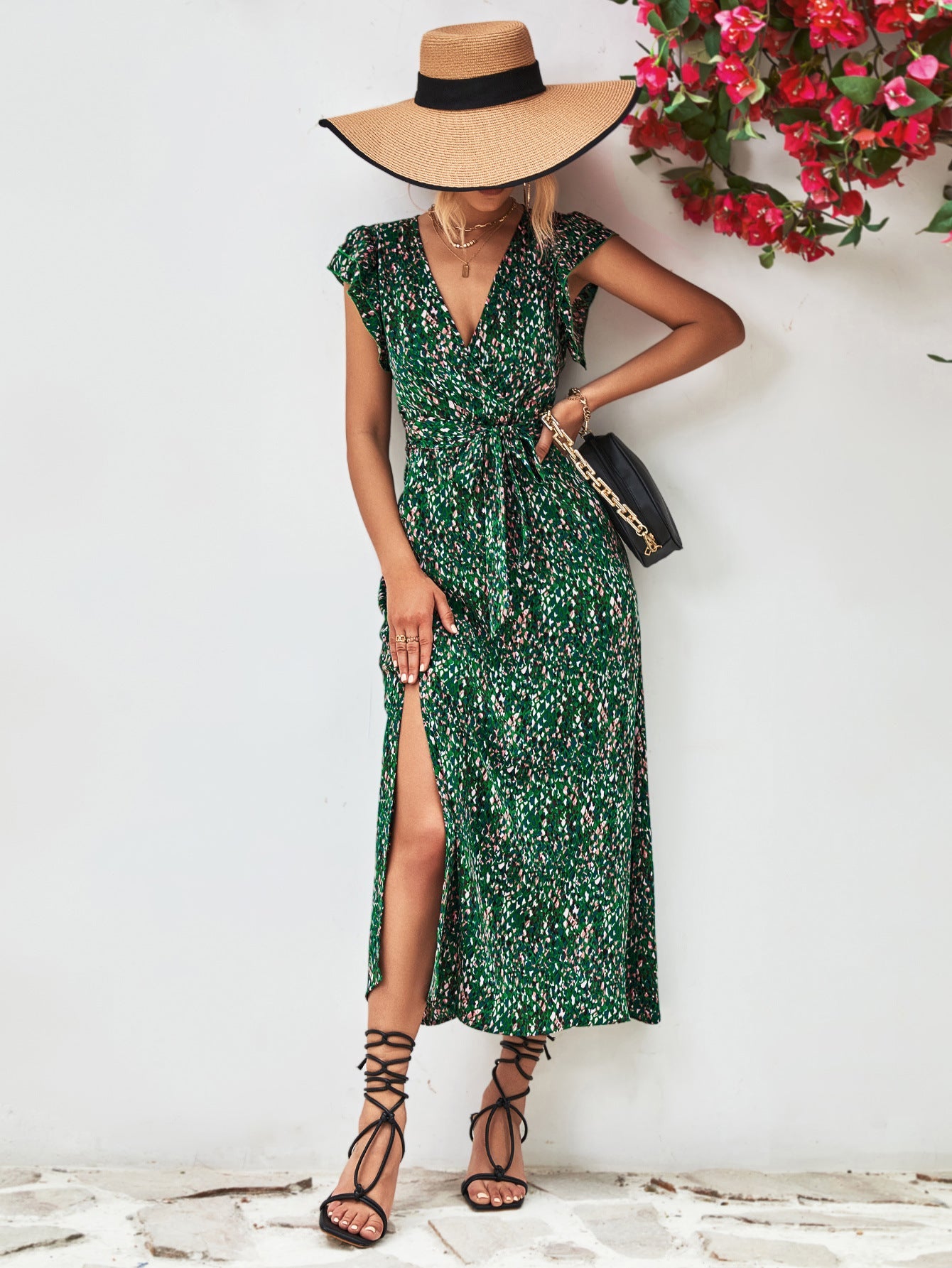 Green floral wrap midi dress with flutter sleeves and a high slit.