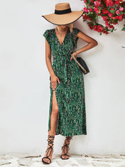 Green floral wrap midi dress with flutter sleeves and a high slit.