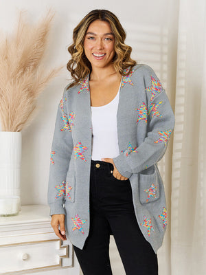 Gray acrylic knit cardigan with colorful starburst pattern and pockets.