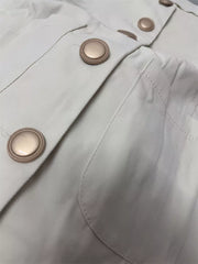 Cream cotton button-down sleeveless vest with crew neck and gold buttons.