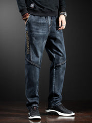 Men's dark wash loose fit drawstring jeans with distressed details and side text