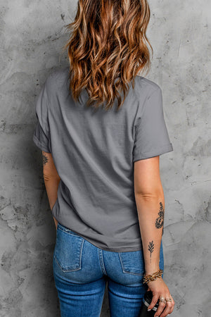 Dark gray cotton t-shirt with rolled sleeves and a relaxed fit, styled with jeans.