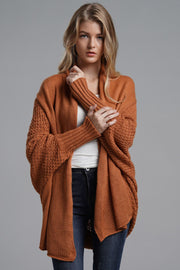 Brick drape-front batwing knit cardigan with textured sleeves and ribbed cuffs.