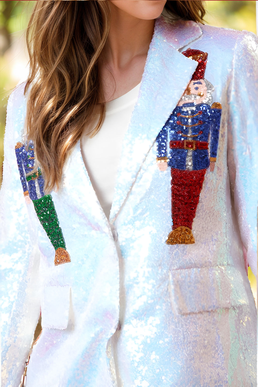 White sequin blazer with buttoned front and nutcracker appliqué details.