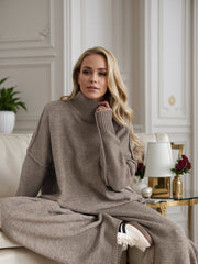 Oversized taupe acrylic turtleneck lounge set with wide sleeves and matching wide-leg pants.