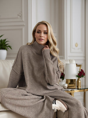 Oversized taupe acrylic turtleneck lounge set with wide sleeves and matching wide-leg pants.