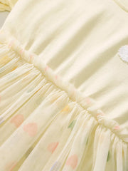Beige baby dress with rainbow heart applique on tulle skirt and cotton top.