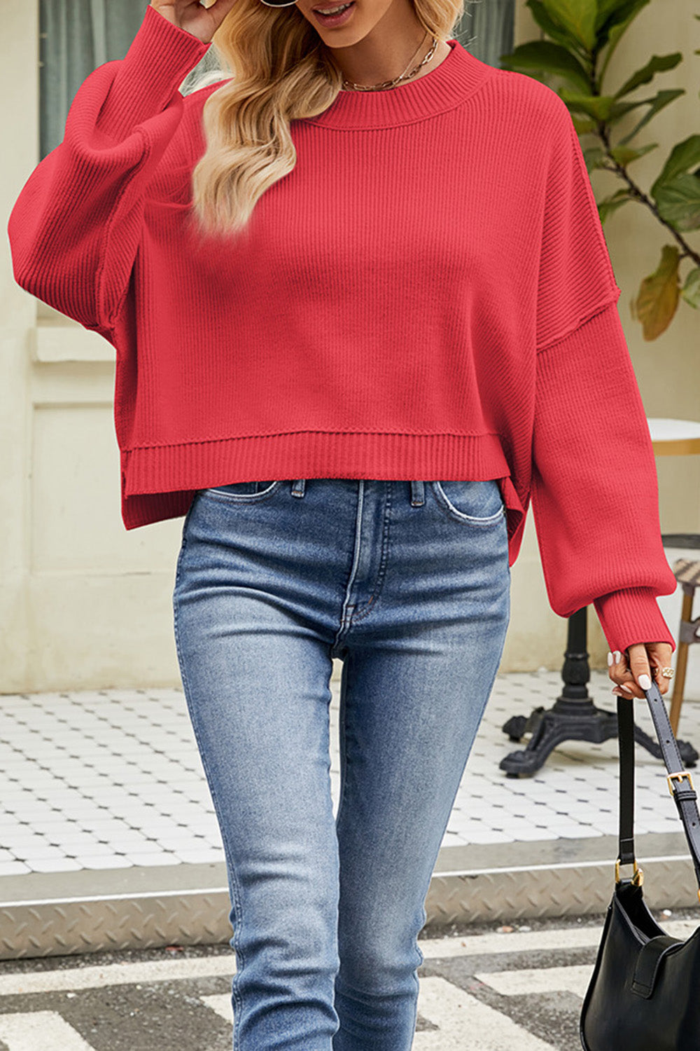 Red boxy ribbed knit sweater with crewneck and balloon sleeves.