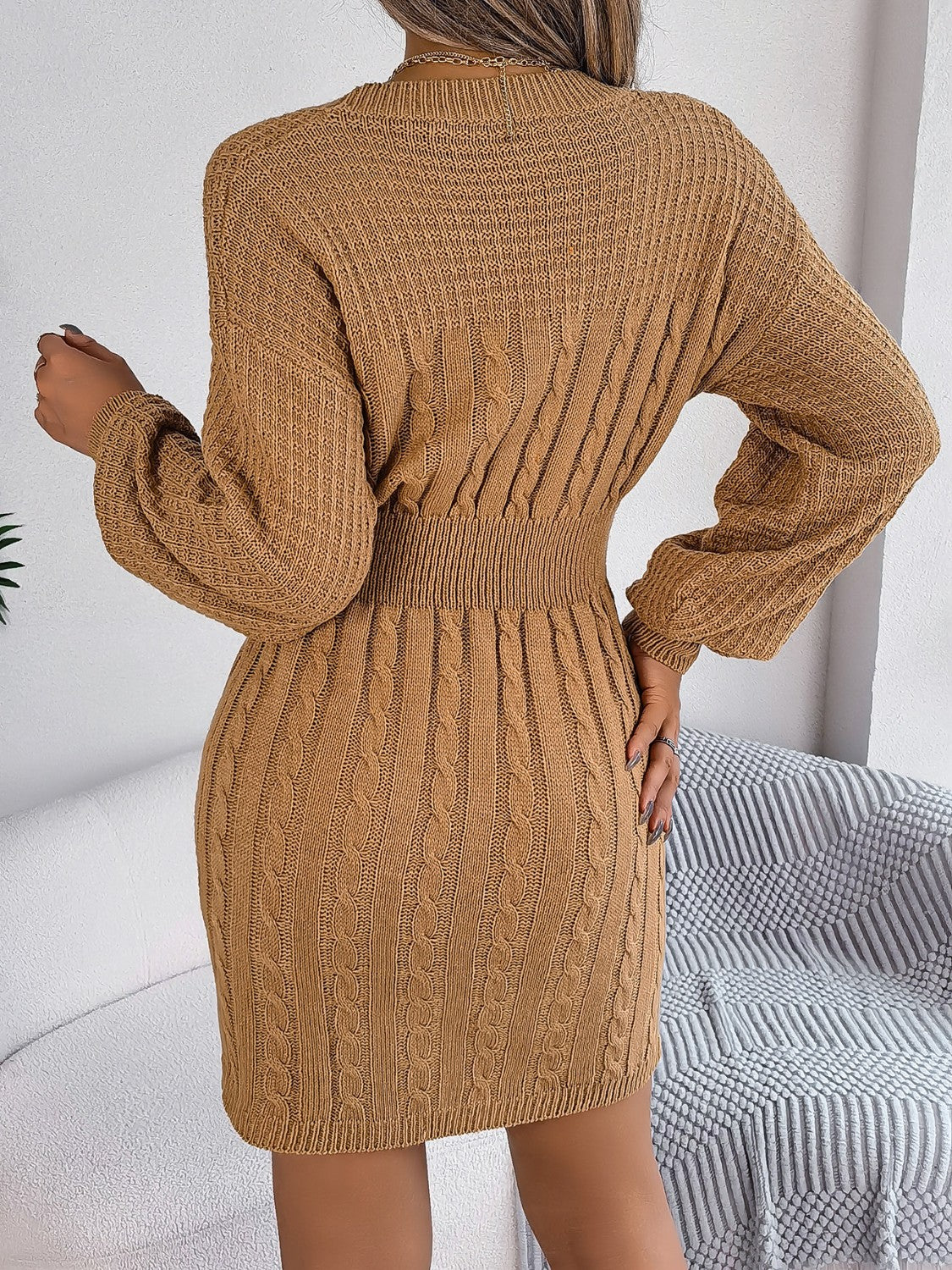 Tan cable knit mini dress with ribbed waist and long sleeves