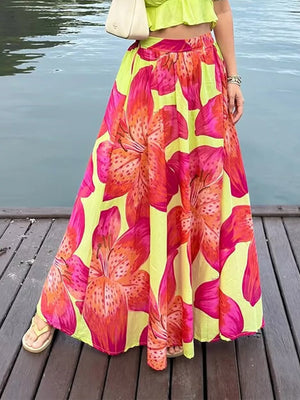 Vibrant floral maxi skirt with pockets in bright pink and orange lily print on yellow.