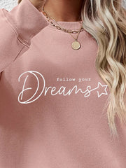 Dreams Scripted Oversized Sweatshirt in Blush Pink with crewneck and ribbed cuffs.