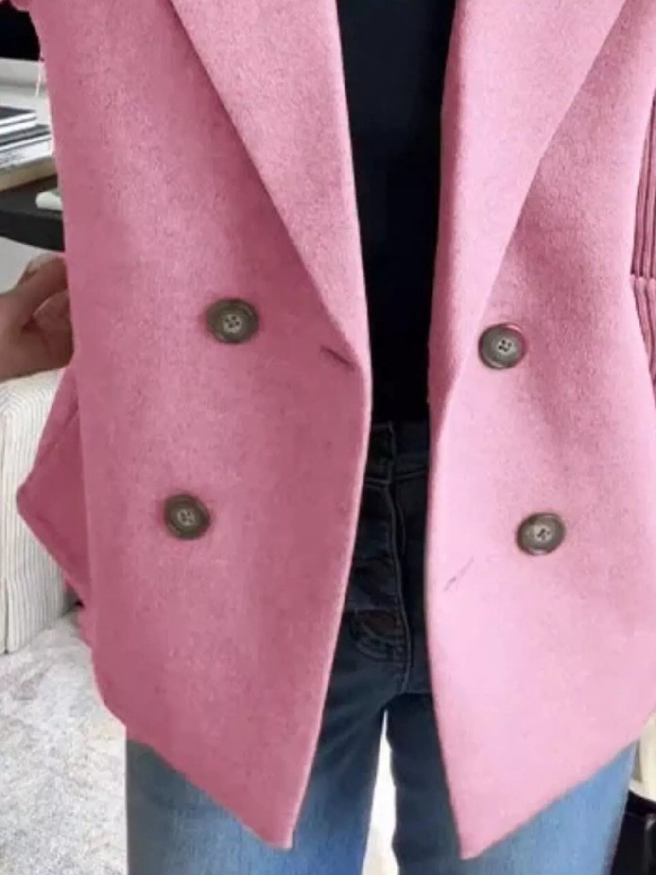 Pink double-breasted knit sleeve outerwear jacket with four buttons and lapel collar.