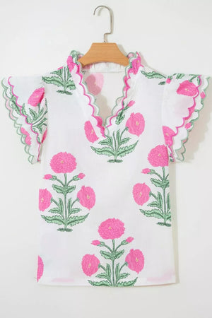 White cotton blouse with vibrant pink floral print and scalloped trim