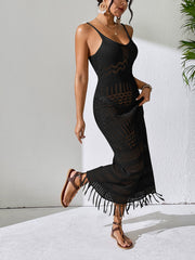 Black crochet maxi dress with fringe hem and V-neck, styled with sandals.