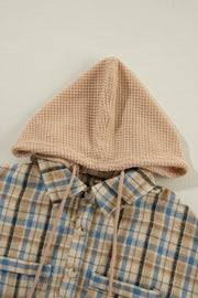 Textured plaid hooded overshirt with drawstring and raw hem detail.