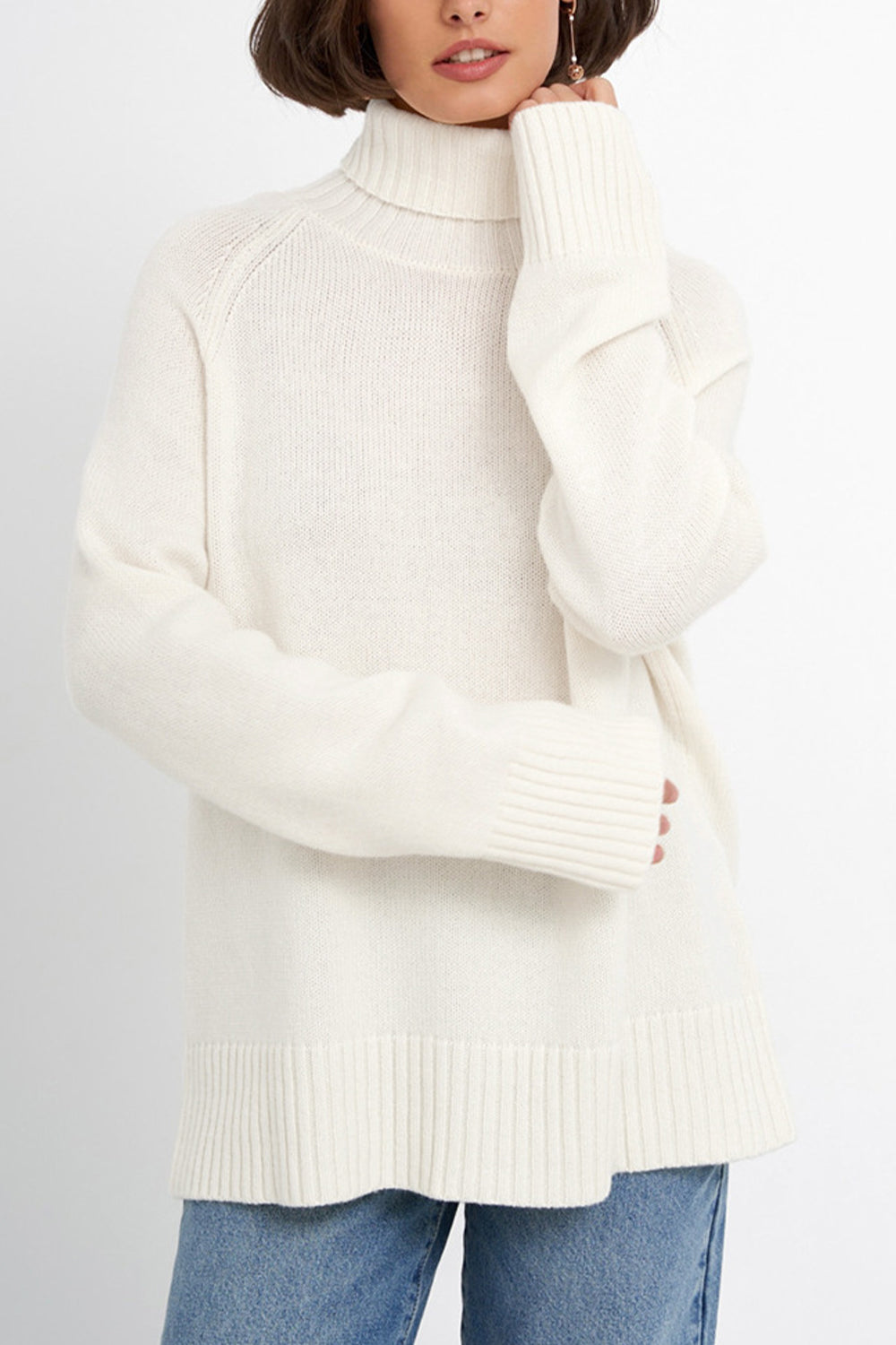 White cashmere turtleneck sweater with raglan sleeves and ribbed cuffs and hem.