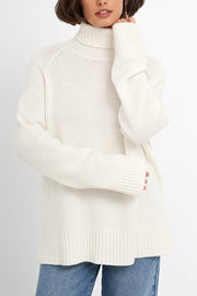 White cashmere turtleneck sweater with raglan sleeves and ribbed cuffs and hem.