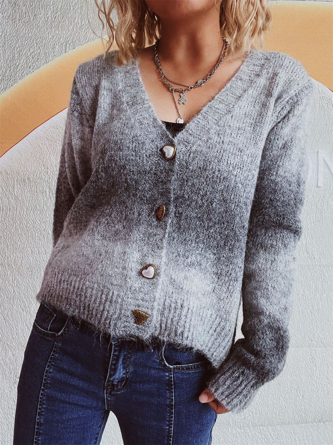 Gray ombre knit cardigan with heart buttons and a V-neck.