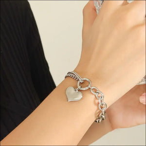 Silver heart charm bracelet with chunky chain and braided detail