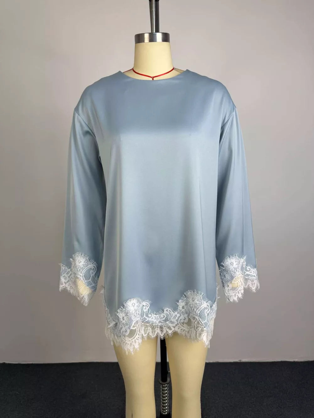 Light blue satin maternity t-shirt with lace trim at hem and cuffs.
