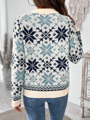 Snowflake Fair Isle crewneck sweater in light blue acrylic with a cream ribbed hem and cuffs.