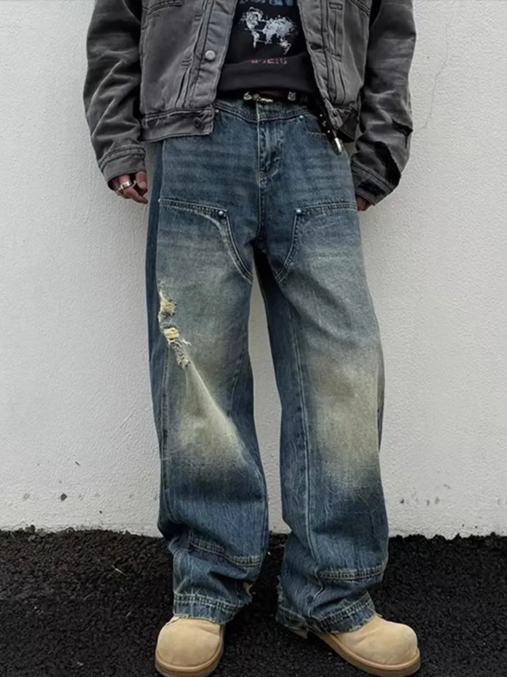 Distressed dark wash wide-leg jeans with a relaxed fit and faded details.