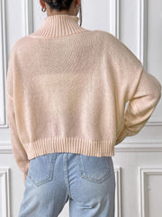 Blush pink knit turtleneck sweater with ribbed cuffs and hem, shown from the back.