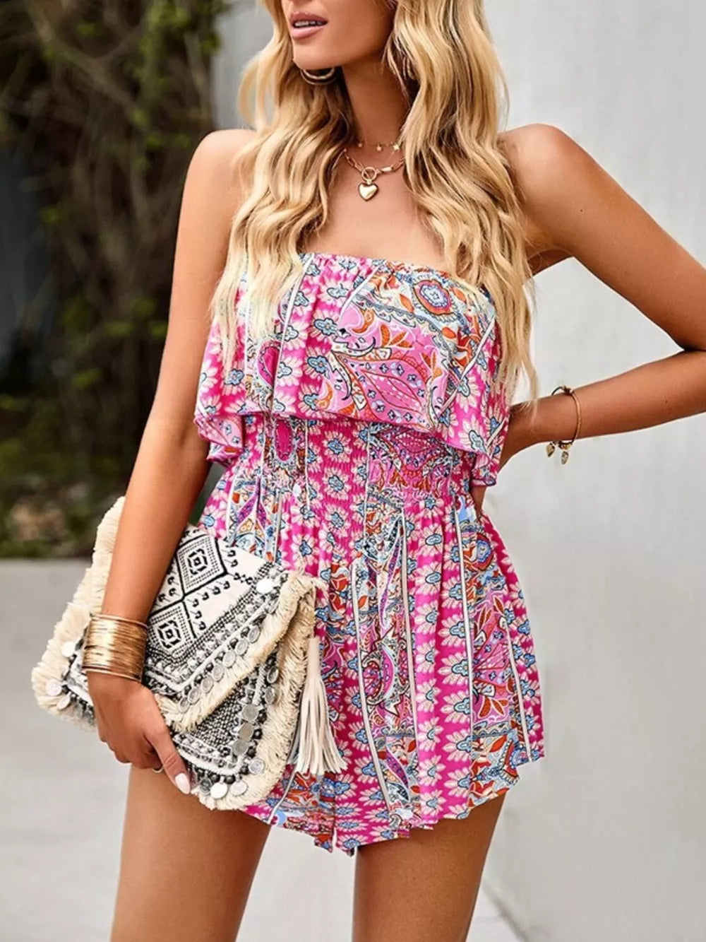 Strapless pink boho romper with smocked waist and paisley print.