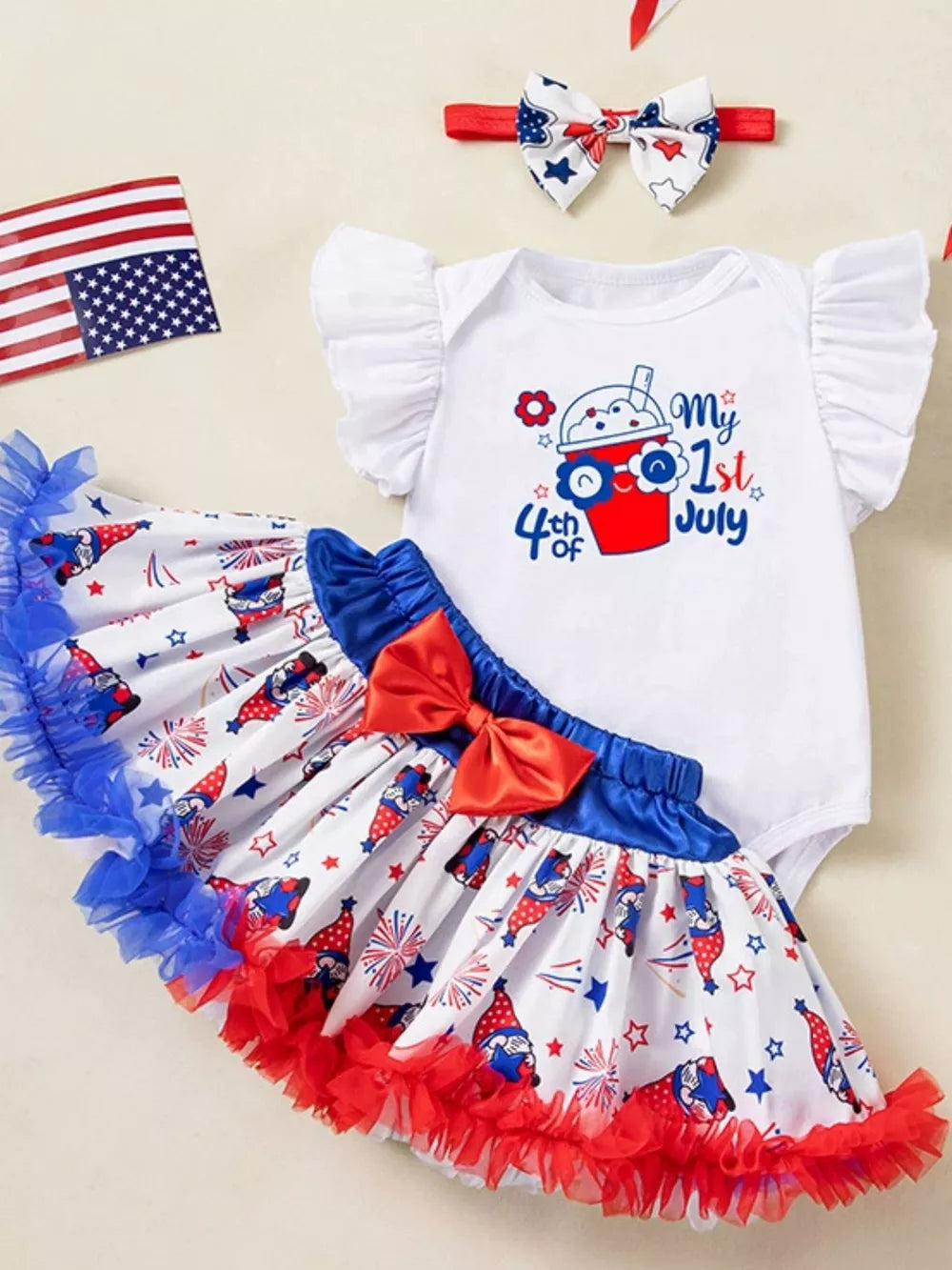 Baby outfit set with white ruffled sleeve bodysuit and patriotic gnome print skirt.