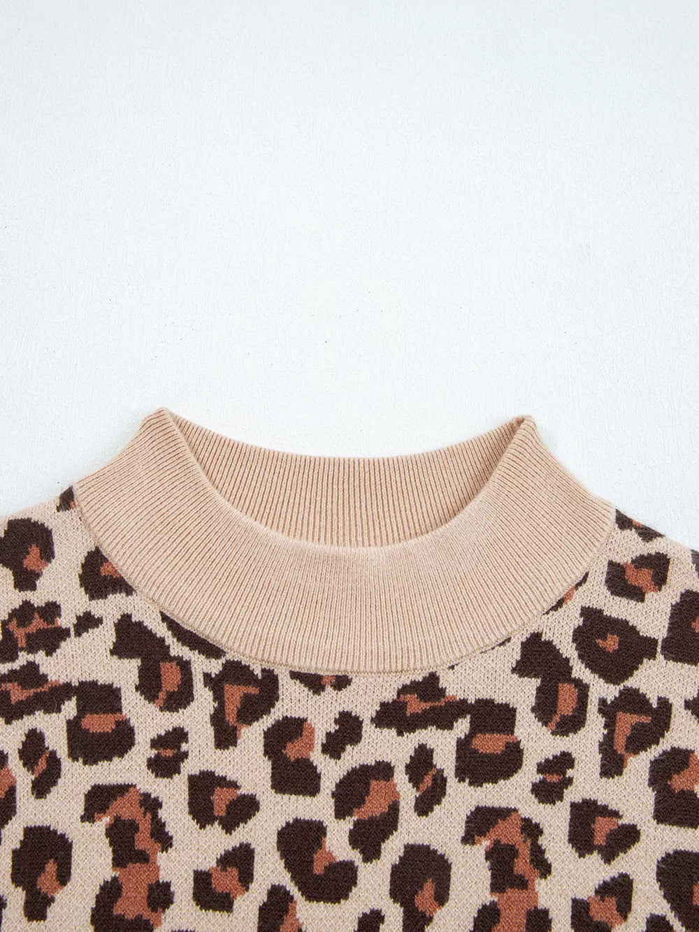 Leopard print ribbed high neck sweater dress with beige mock neck detail.