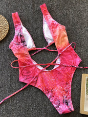 Snakeskin plunge swimsuit in hot pink with crisscross back straps and a deep V-neck.