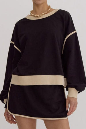 Black sweatshirt and skort set with contrast trim and tan neckline