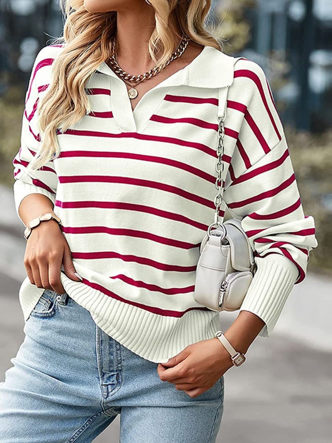 Striped polo knit sweater in cream with burgundy stripes, featuring a collar and v-neck.