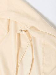Backless ruffled mini dress in cream with a metal ring detail at the back closure.