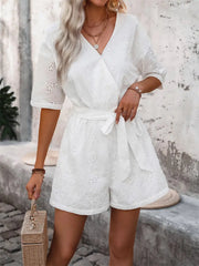 White eyelet wrap romper with tie waist and short sleeves