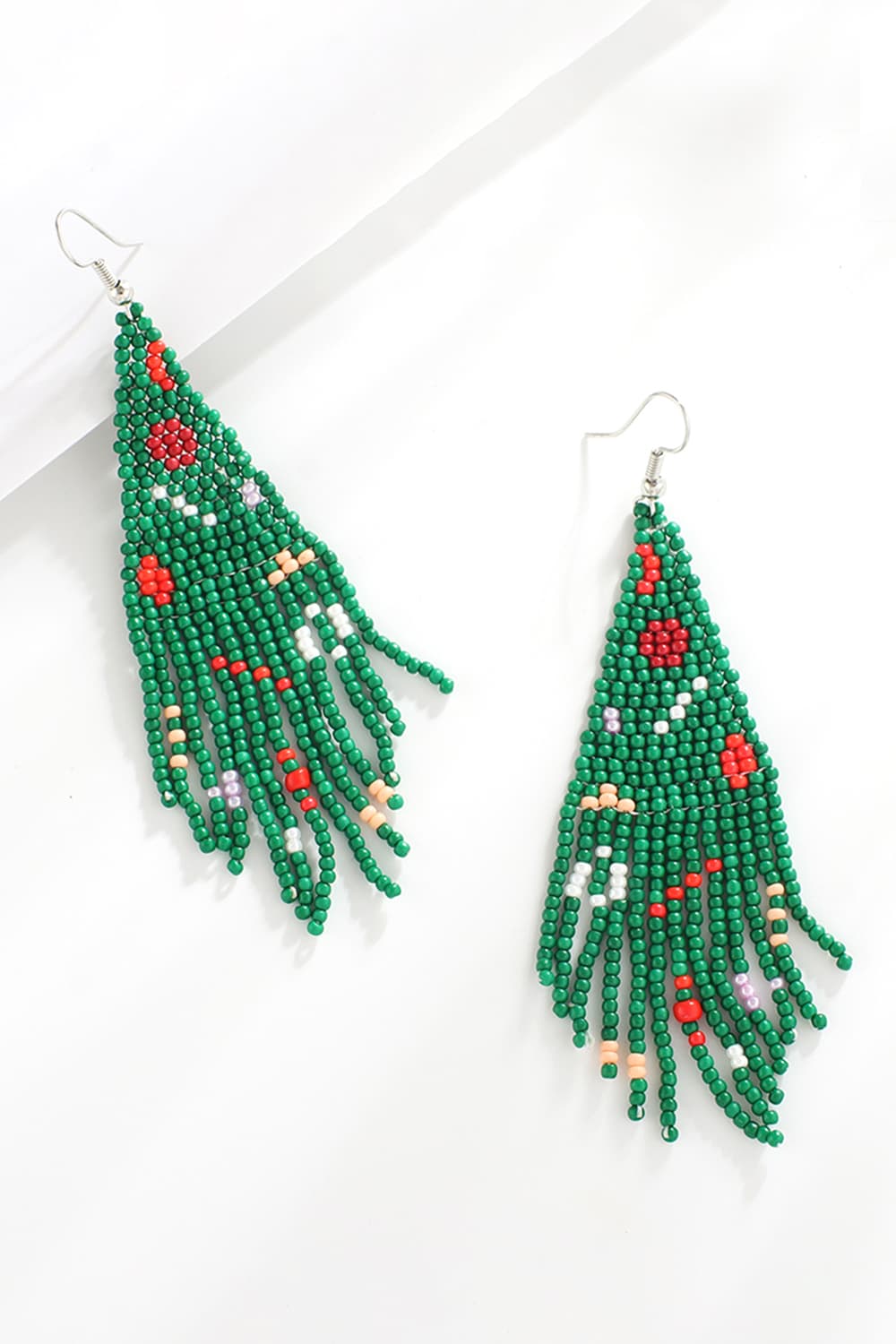 Green beaded Christmas tree drop earrings with red and white accents.